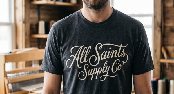 All Saints Supply Co. logo tee — charcoal heather unisex T-shirt